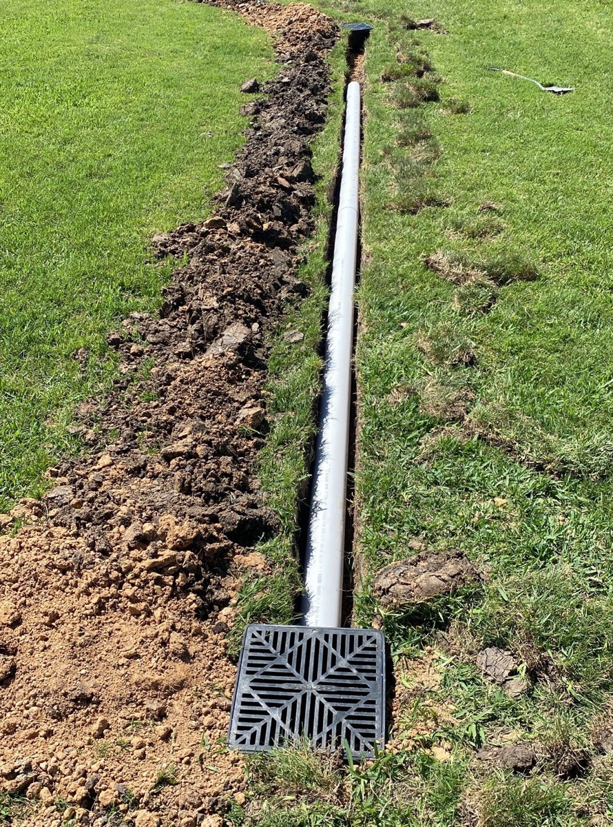 Catch basins and solid PVC pipe set in the trench before backfill