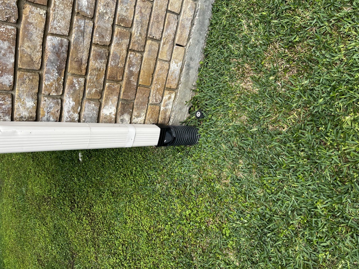 Professional downspout extension connection installed at a Houston TX home