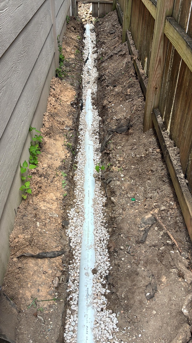 Professional drainage installation in a Katy, TX residential yard